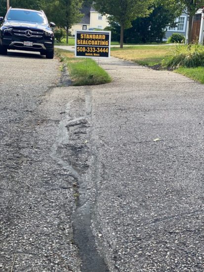 Neat driveway sealcoating job with some light patching in Shrewsbury MA