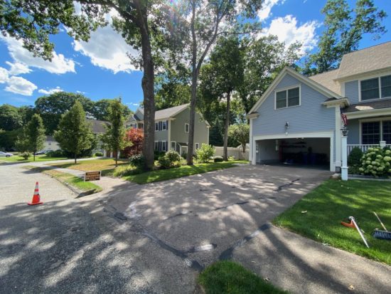 Neat driveway sealcoating job with some light patching in Shrewsbury MA