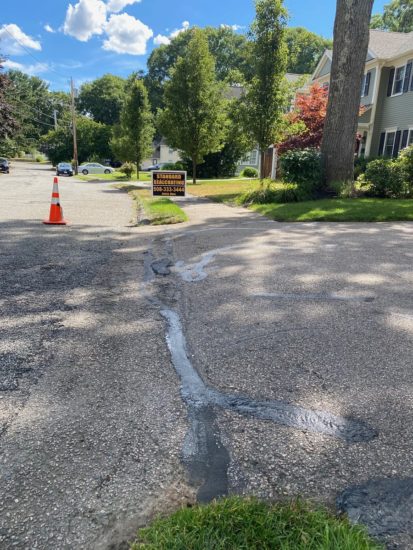 Neat driveway sealcoating job with some light patching in Shrewsbury MA