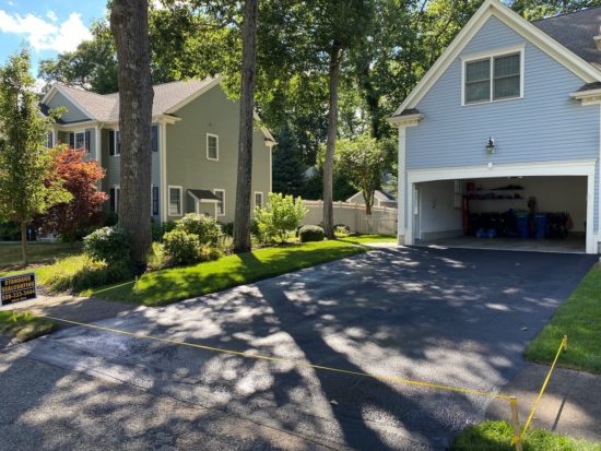 Neat driveway sealcoating job with some light patching in Shrewsbury MA