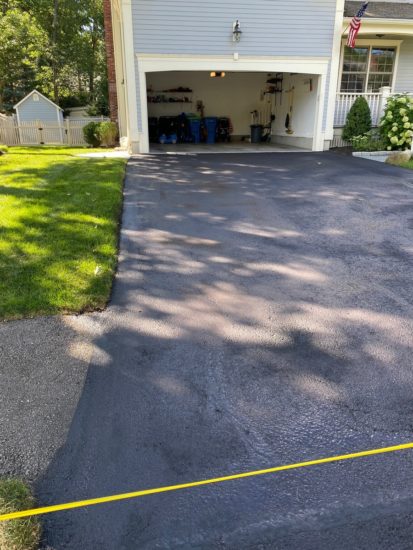 Neat driveway sealcoating job with some light patching in Shrewsbury MA