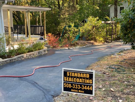 Driveway sealcoating in Millbury, Massachusetts.