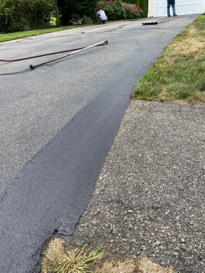 Worcester MA driveway cracks sealed using hot kettle rubber and home driveway sealcoated