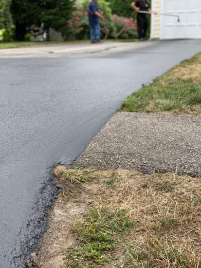 Worcester MA driveway cracks sealed using hot kettle rubber and home driveway sealcoated