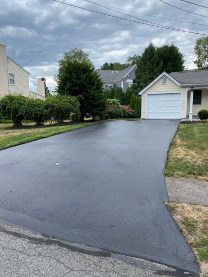 Worcester MA driveway cracks sealed using hot kettle rubber and home driveway sealcoated