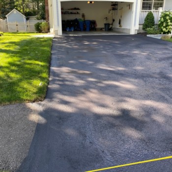 Neat driveway sealcoating job with some light patching in Shrewsbury MA