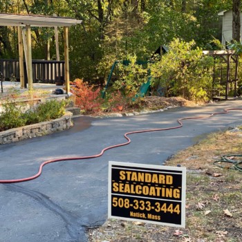 Driveway sealcoating in Millbury, Massachusetts.