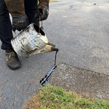 Worcester MA driveway cracks sealed using hot kettle rubber and home driveway sealcoated